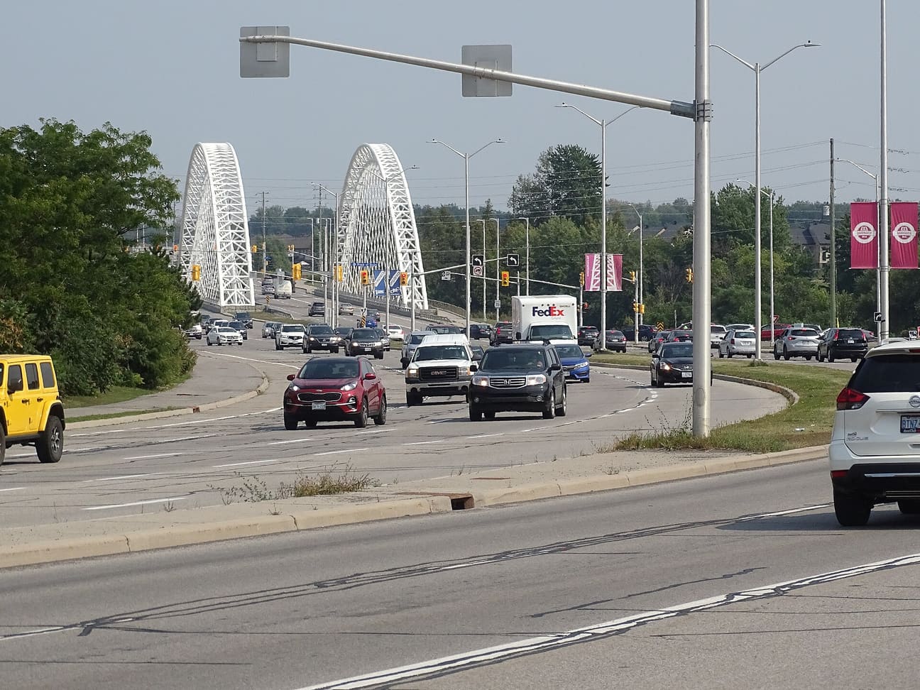 Strandherd Drive in Barrhaven, Ottawa, looking east to the white arches of the Vimy Memorial Bridge