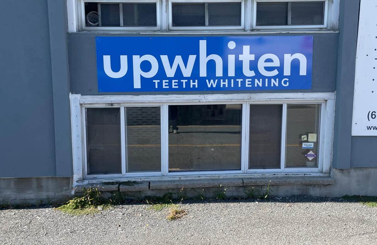 The UpWhiten Teeth Whitening sign on the front of the building at 1915 Baseline Road, Ottawa